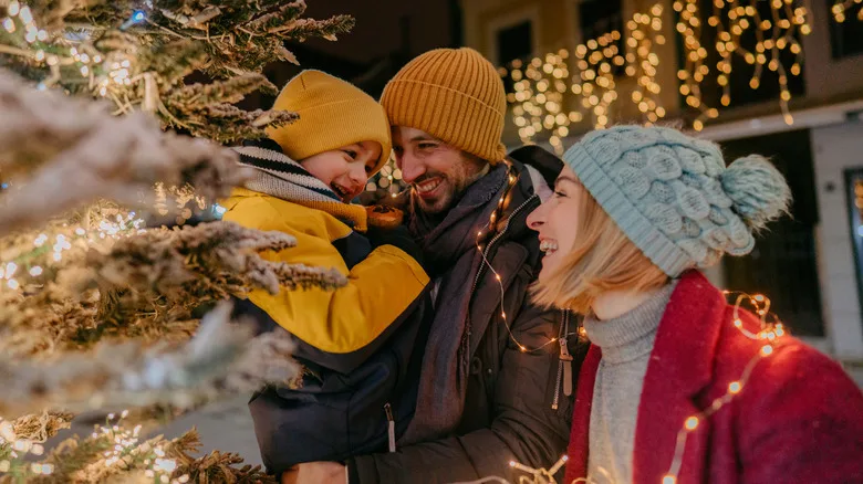 Photo of a young family celebrating Christmas outdoors.