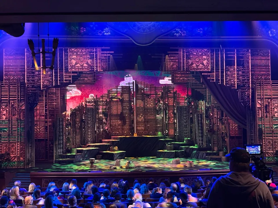 theater stage set with intricate wooden structures and vibrant lighting