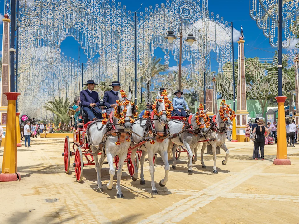 Horse-drawn carriages at the Feria del Caballo. The horses are adorned with flowers.