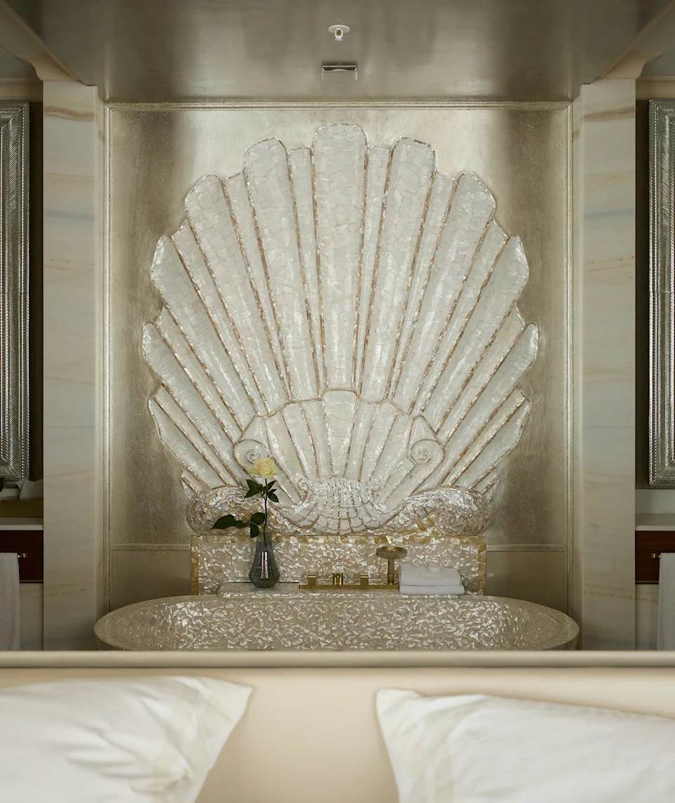 Bathtub in Ludwig Suite of the Vier Jahreszeiten Kempinski hotel in Munichluxurious bathroom featuring a shell design and floral decoration