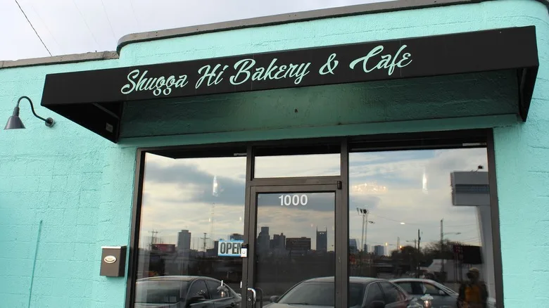Front doors and brick exterior painted light blue at Shugga Hi Cafe