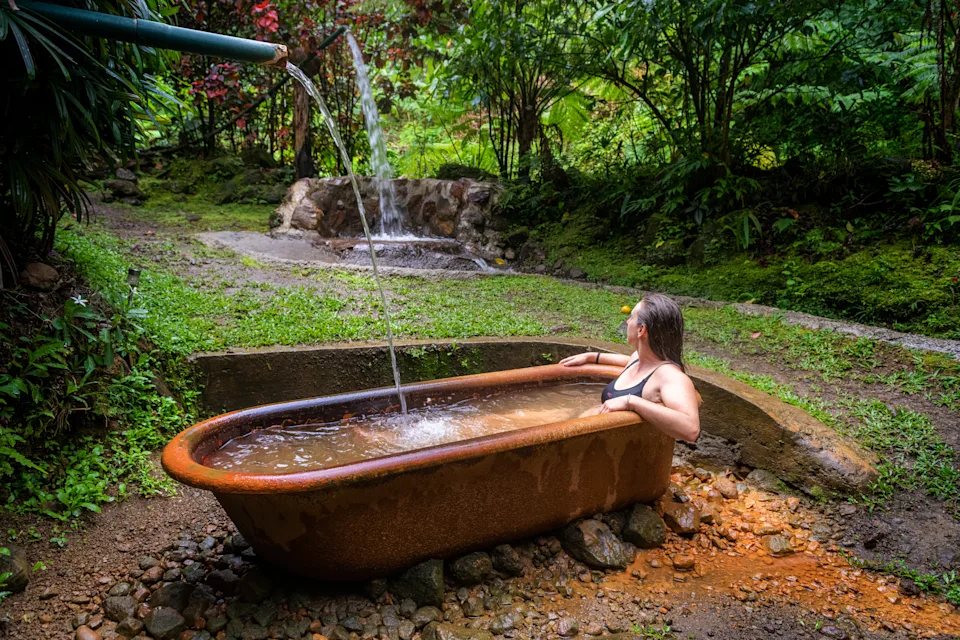 A traveler takes a hot spring bath in Dominica.