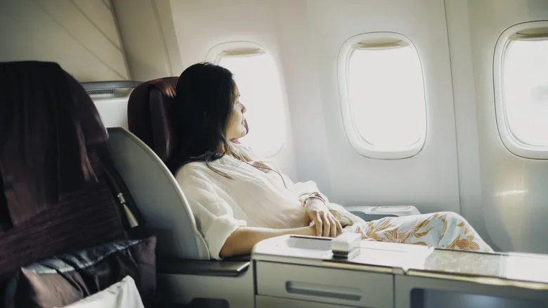 Business class flyer looking out the airplane window