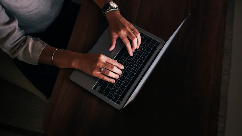 Top down shot of a person's hands on a laptop