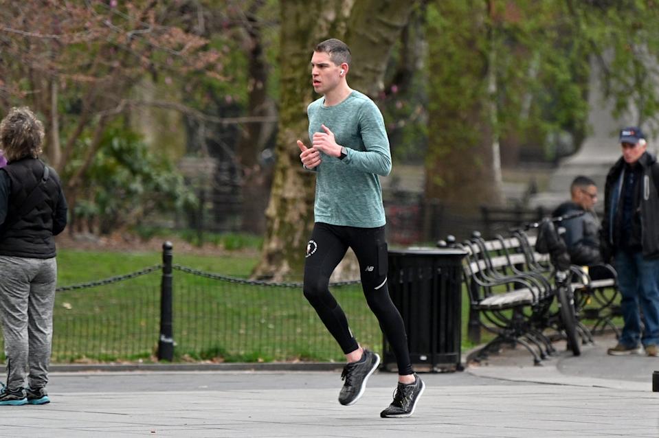 A man runs in New York City’s Washington Square Park in March 2020. People training for races can reduce their risk of injury by incorporating cycling and other cross-training exercises into their workouts (Getty)