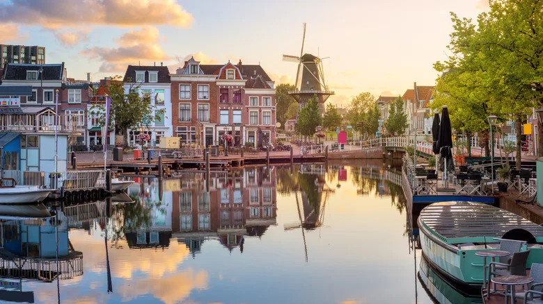 A view of the Beestenmarkt and the De Valk mill reflecting in Rhine river on sunrise, South Holland, Netherlands.