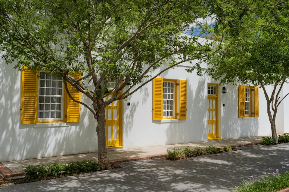 Exterior view of Drostdy Hotel featuring restored Cape Dutch architecture with modern luxury design elements.