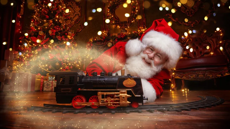 Santa smiling & playing with model steam train