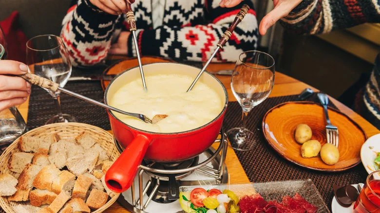 Friends sharing a fondue pot