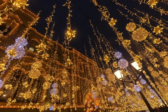 City street decorated with lights for Christmas.