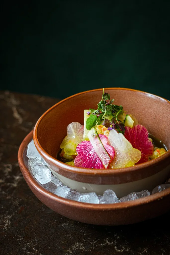 A dish including sliced radishes and other veggies on a bed of ice. Courtesy of Yamashiro