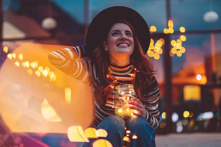 Cheerful woman with Christmas lights