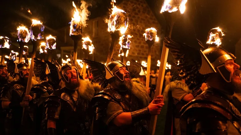 The Guizer Jarl leads with the galley and his guizers through Lerwick