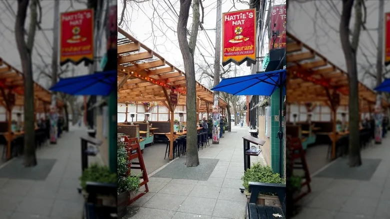 Side shot showing the doorway to Hattie's Hat and, across the sidewalk, the restaurant's outdoor patio