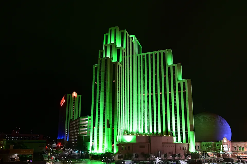 Reno, Nevada - January 17, 2020: Silver Legacy Resort Casino illuminated green at night in winter.