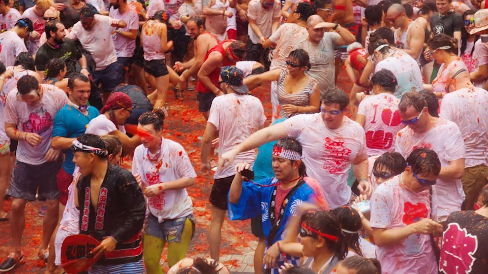 BUNOL, SPAIN - AUGUST 28: La Tomatina festival - tomatoes madness in August 28, 2013 in Bunol, Spain. Battle of tomatoes at street of city