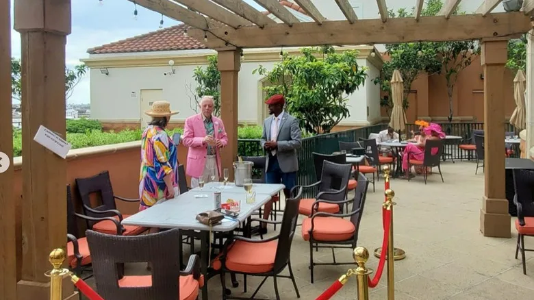 The Waterscapes Restaurant terrace seating area with guests standing and talking