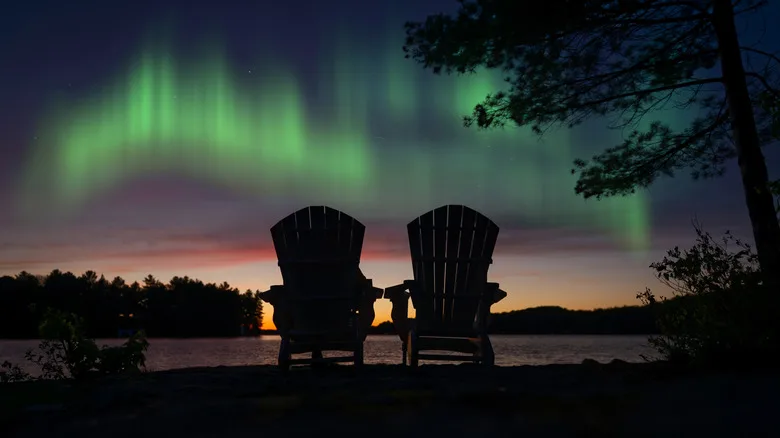 Two Adirondack chair looking out over northern lights