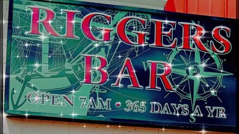 A sign for Riggers Bar saying it's open at 7 am, 365 days a year