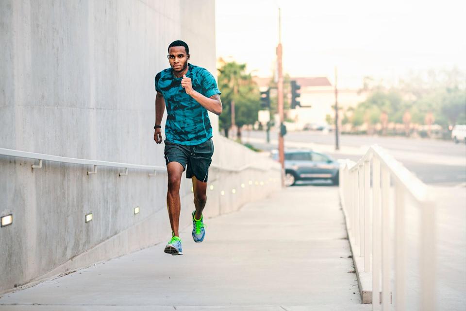 young man running up city footbridge