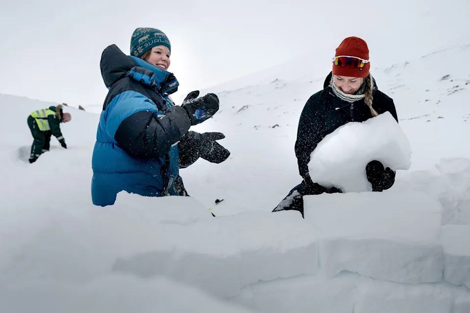 Local residents work on an igloo during the Easter celebration in Longyearbyen, in the Norwegian archipelago of Svalbard, on April 15, 2022. Longyearbyen's population of 2,500 includes people from about 50 countries.