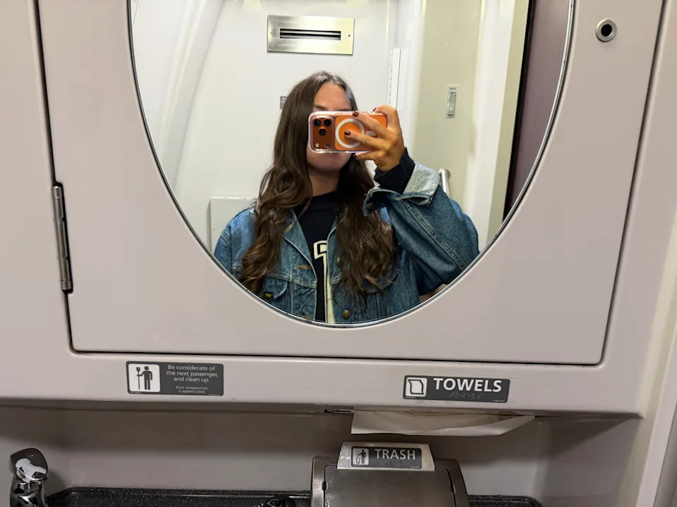 Amanda taking a selfie in an Amtrak bathroom.