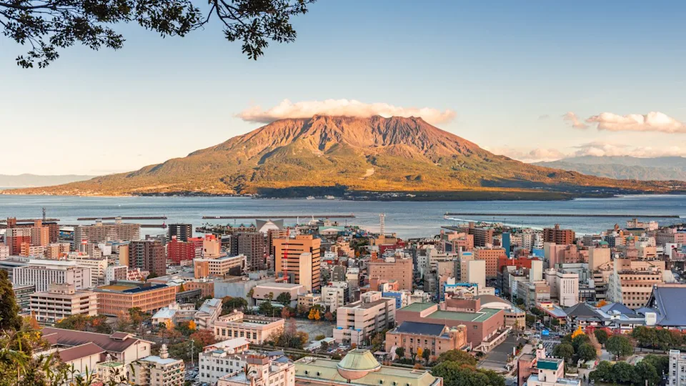 Kagoshima, Japan skyline with Sakurajima Volcano at dusk.