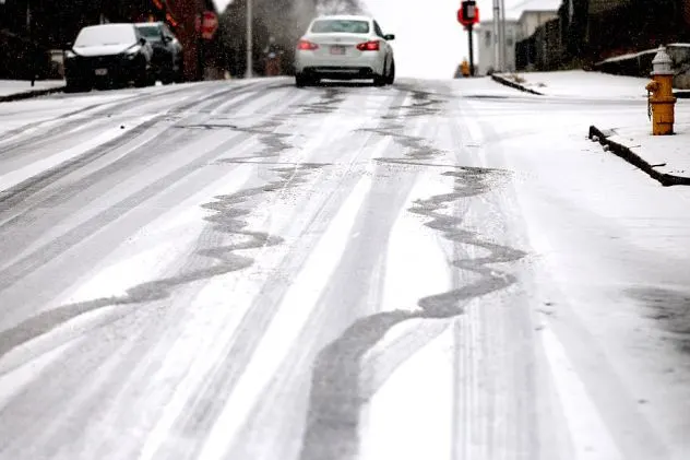A driver struggles to get up Dorchester Street as snow falls on December 2, 2025.