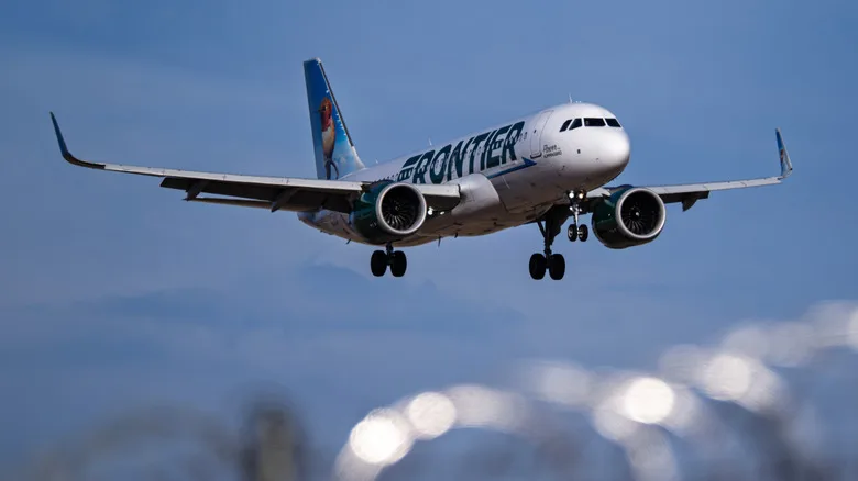 An Airbus A320Neo aircraft from Frontier Airlines' fleet arriving at Phoenix Sky Harbor International Airport in Arizona in the evening.