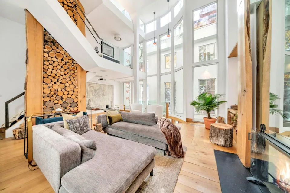 The great room boasts floor-to-ceiling windows. LuxQue Media – Mike Aghachi