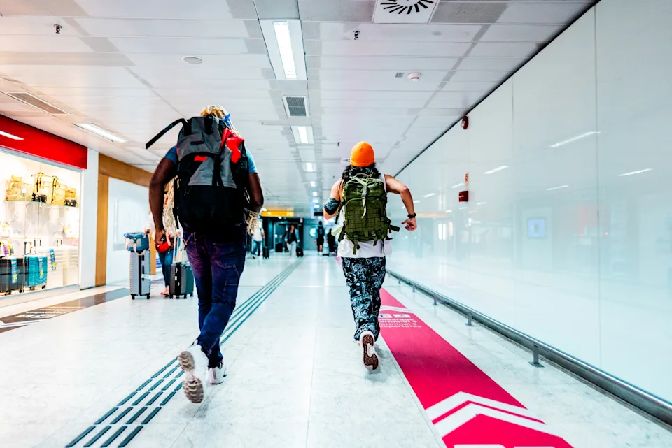 Friends running at the airport