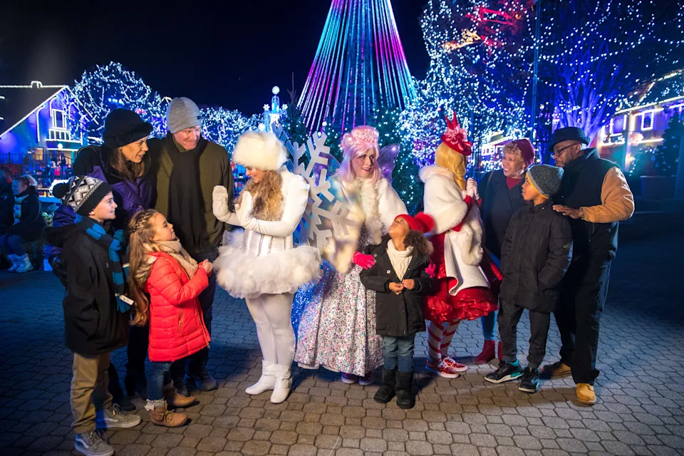 Families interact with performers during WinterFest at Kings Island.