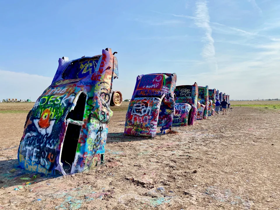 Spray painted Cadillac cars on display in the desert.