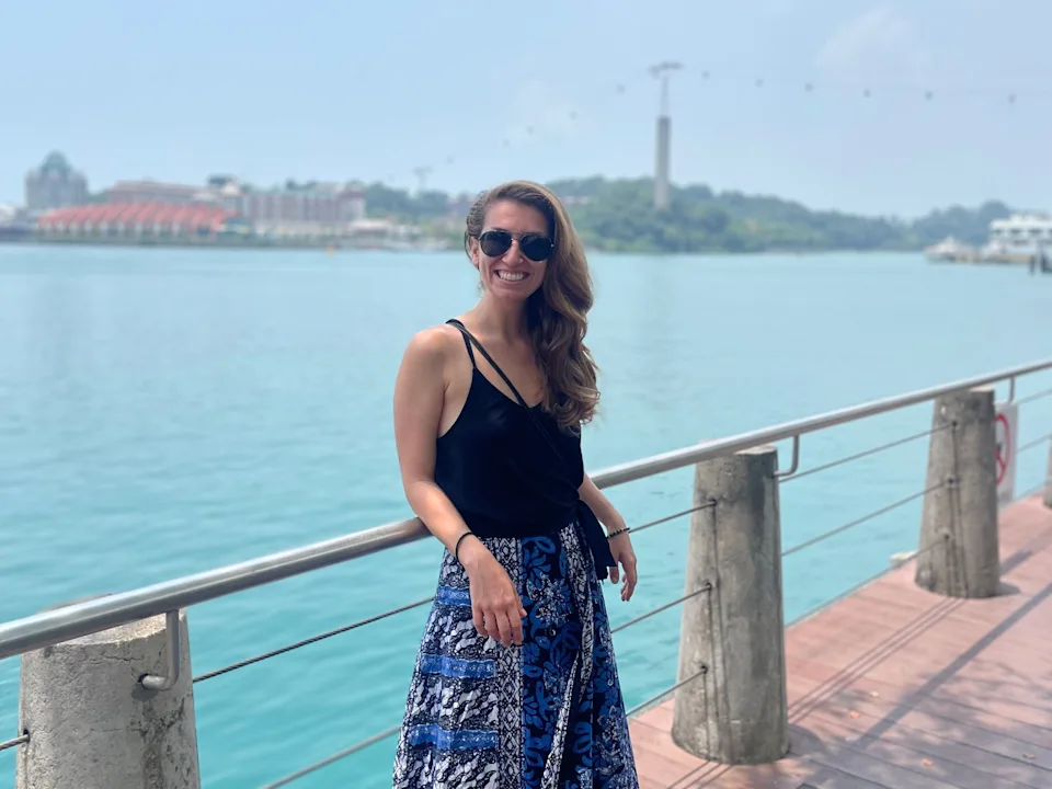 Maria Laposata posing with Singapore and Sentosa in the background.