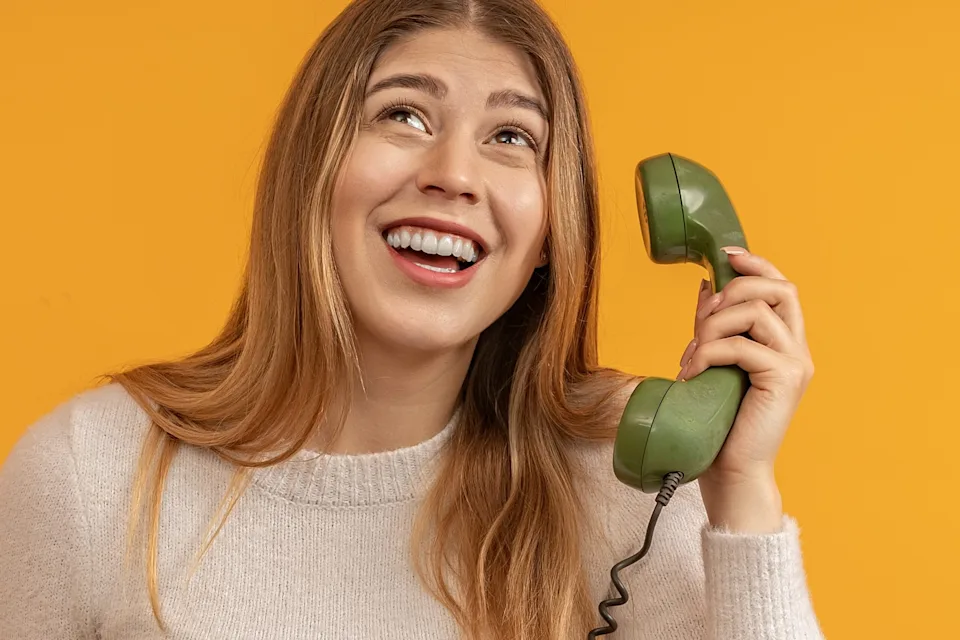 Young woman on an old fashioned phone.