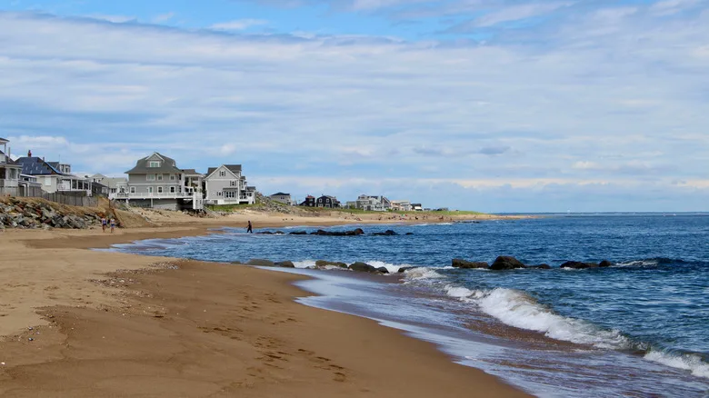 The shoreline at Plum Island Newburyport with wooden buildings in the background