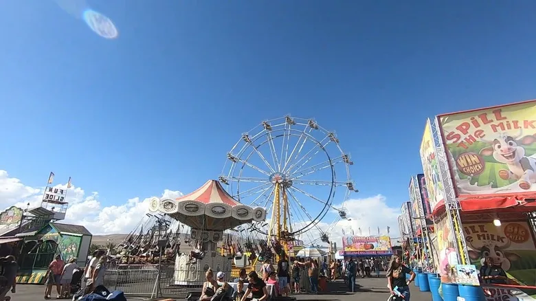 A crowd and ferris wheel at Box Elder County Fair in Tremonton, Utah