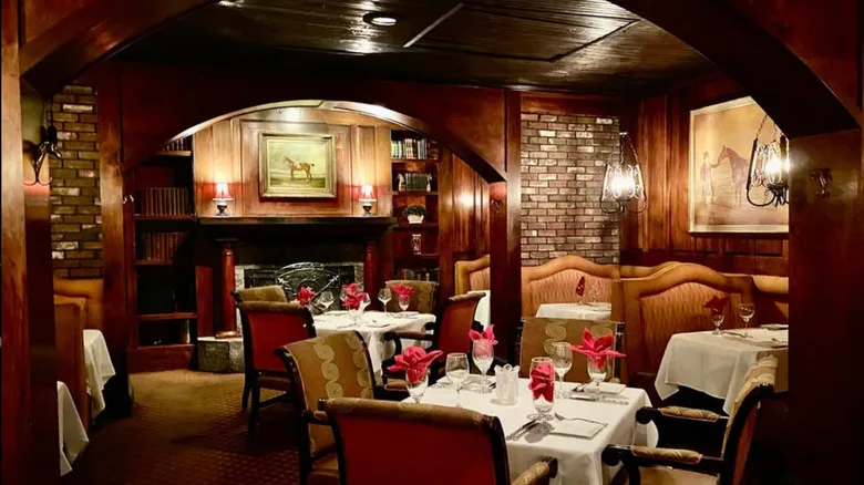 The dimly lit dark wood dining room of Thoroughbreds Chophouse