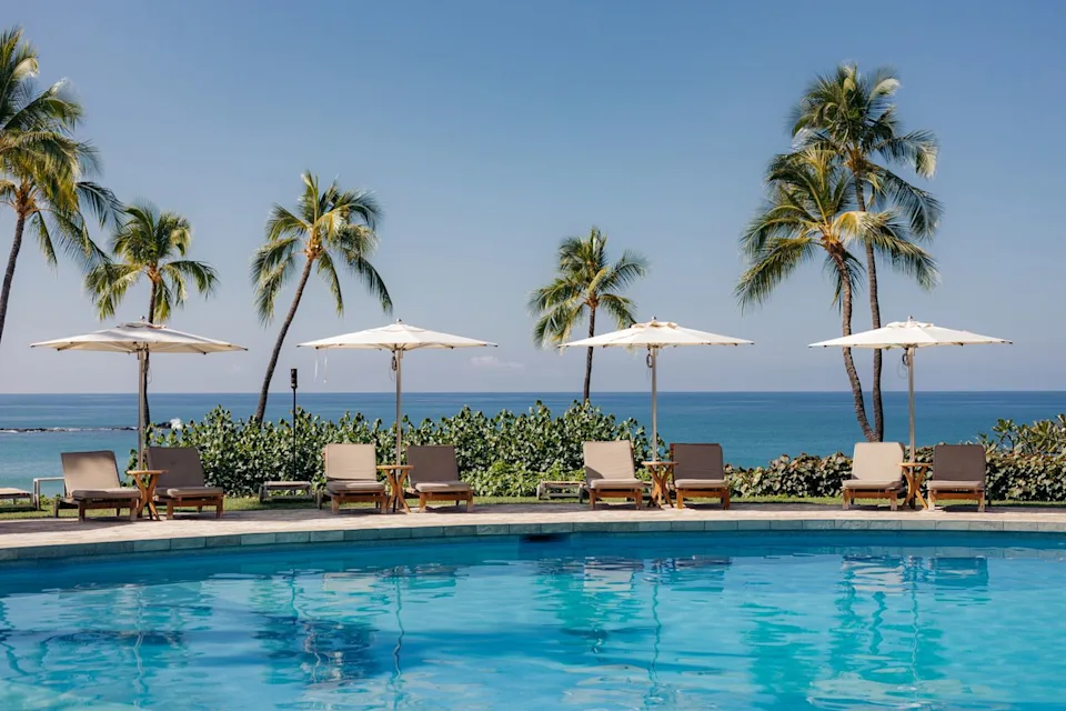 Mauna Kea Beach Resort Lounge chairs by a pool at Mauna Kea Beach Resort.