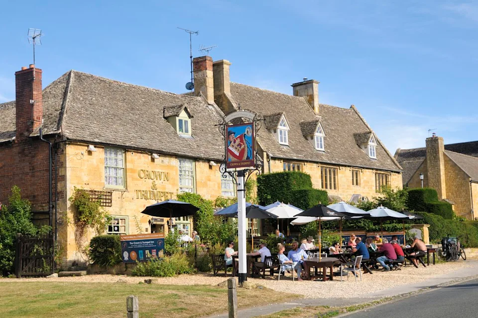 Chris Harris/Universal Images Group/Getty Images Diners outside of the Crown & Trumpet, a traditional pub in Worcestershire.