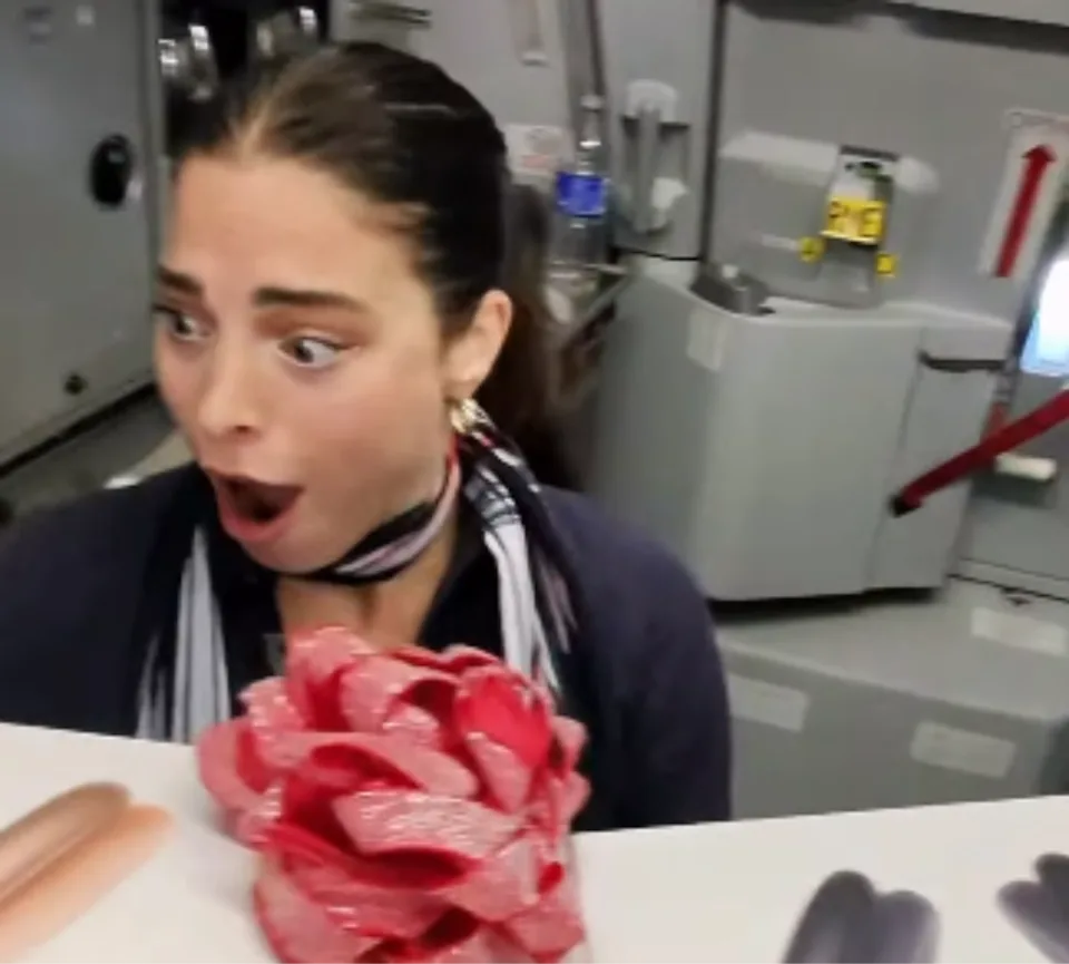 A flight attendant is surprised with boxes of electronics for the crew 