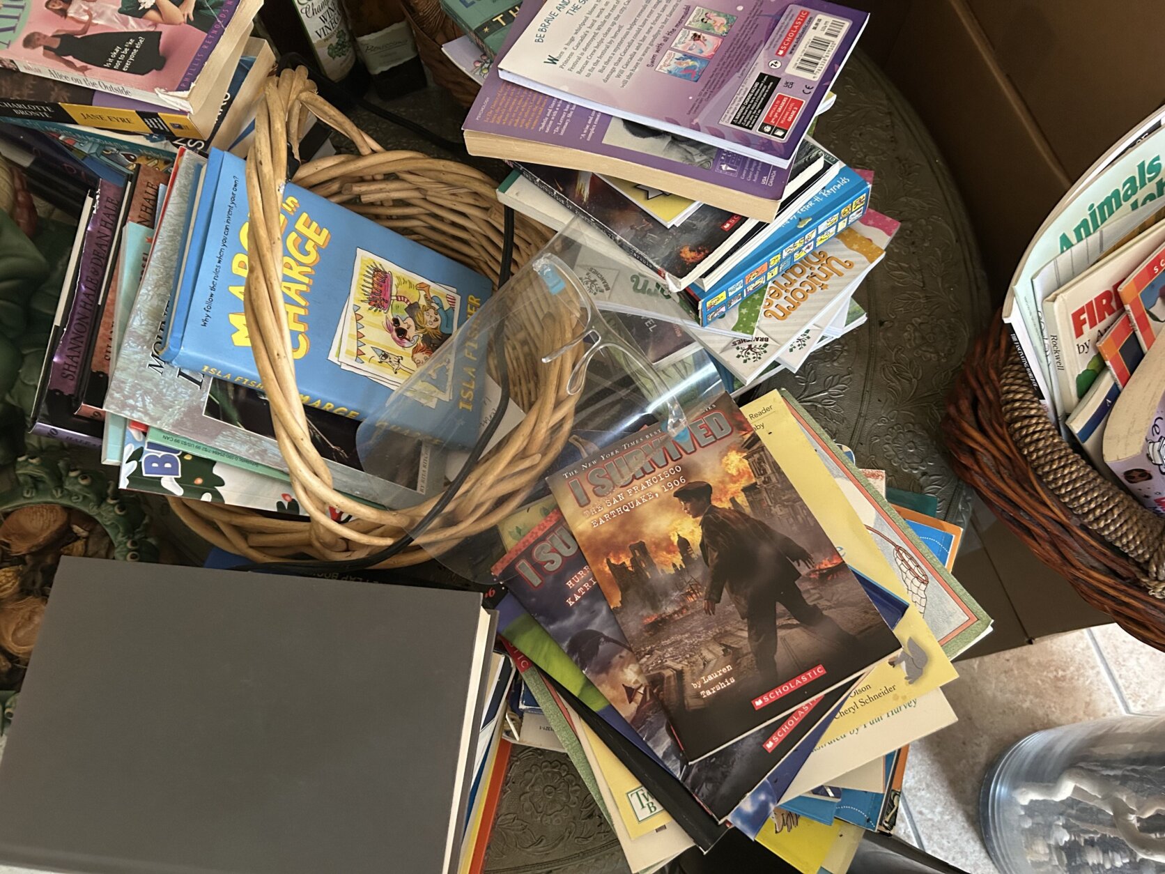 Books strewn across table for book drive at For Love & Buttercup close up