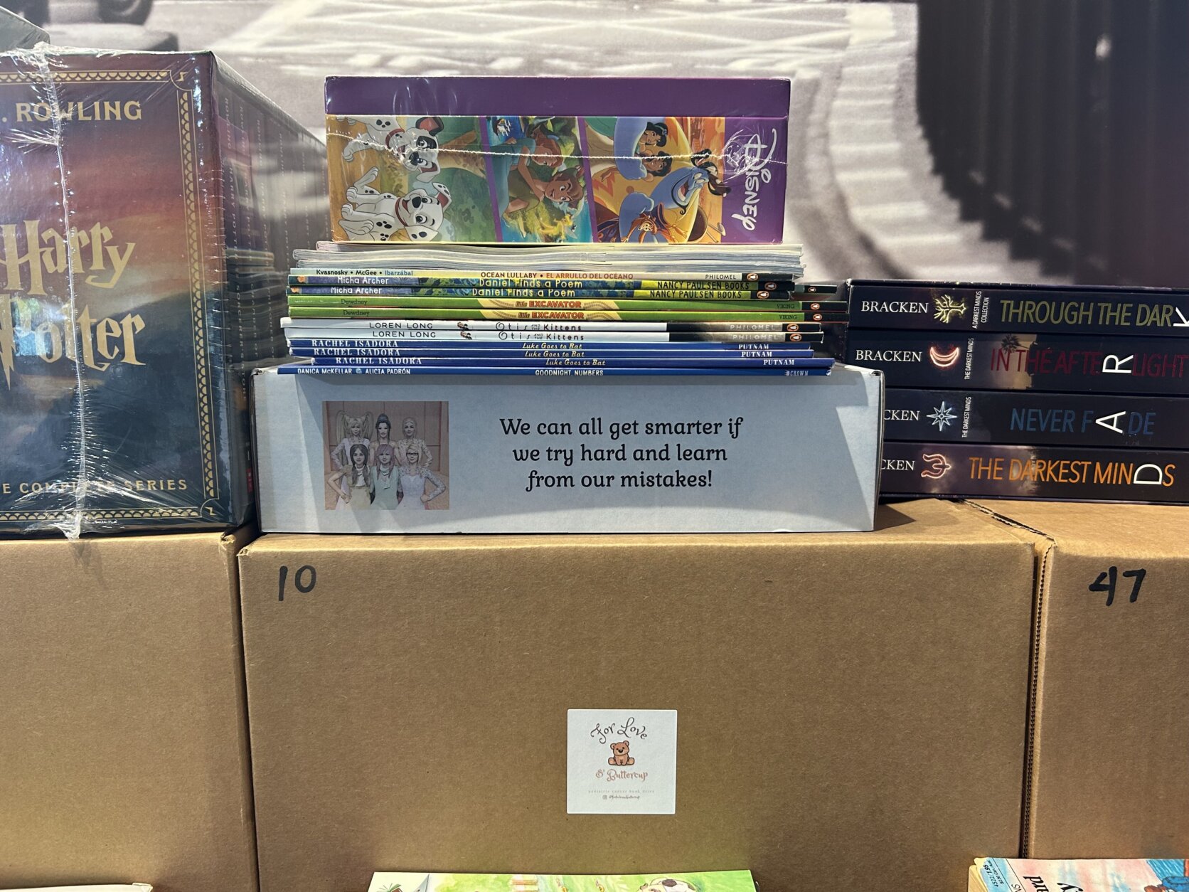 Books stacked for a book drive at For Love & Buttercup