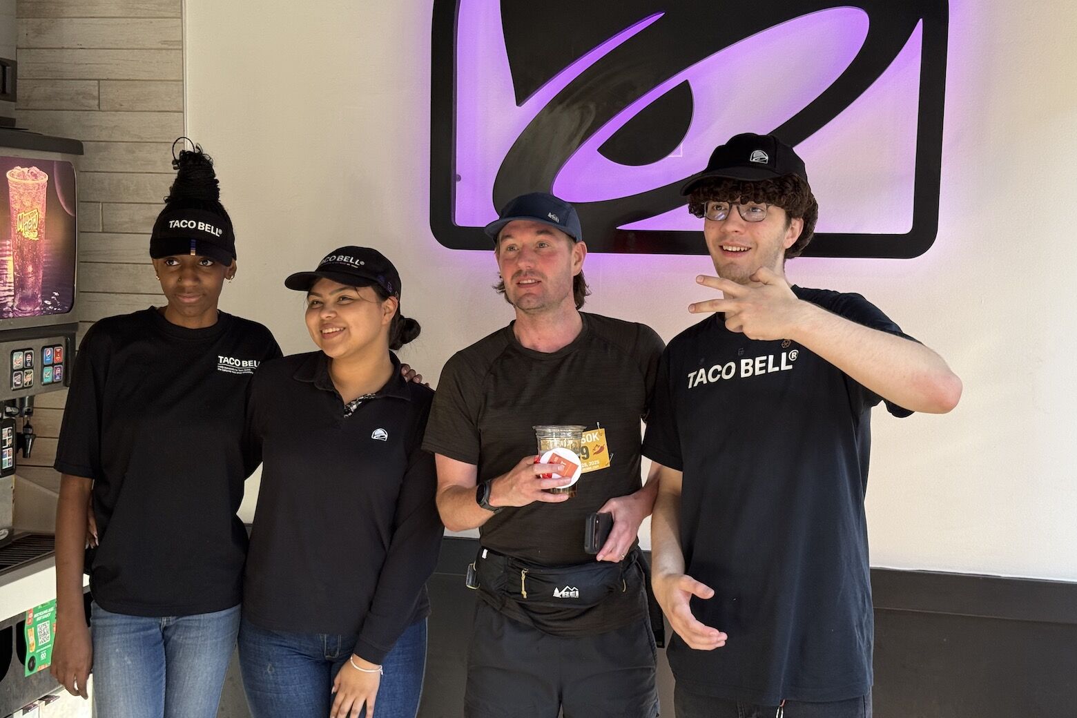 Employees pose with runners during the first DC Taco Bell 50K