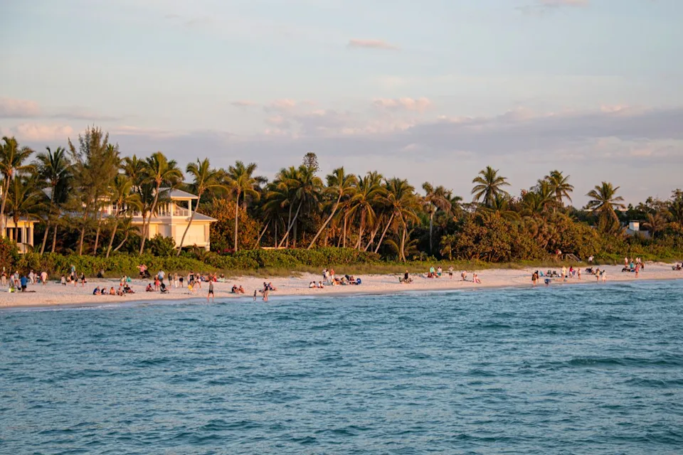 Chris Marinaccio/Travel + Leisure Beachgoers in Naples, Florida.