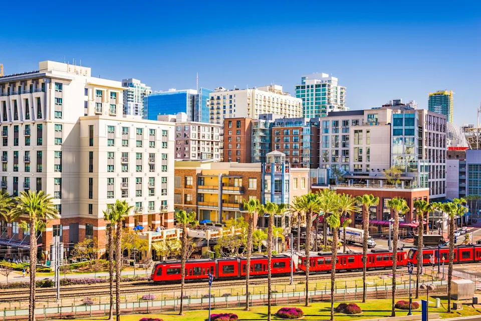 Sean Pavone/Getty Images A public transit train runs through San Diego's Gaslamp Quarter.
