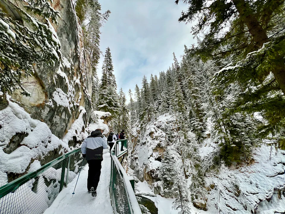 A man walks the Johnston Canyon Icewalk in Banff in winter.