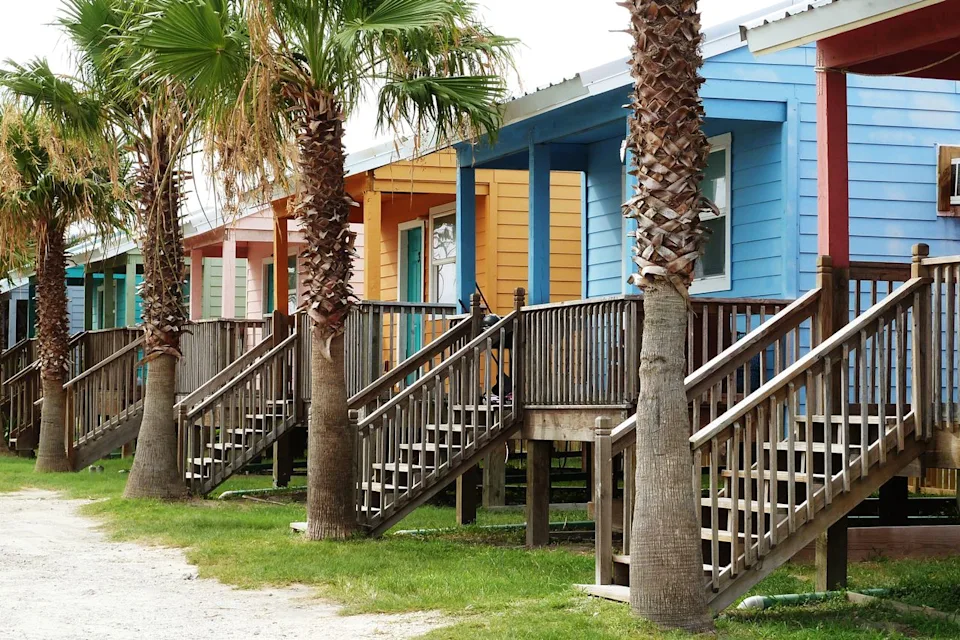 RobertCoy/Adobe Stock Colorful beach bungalows in Rockport, Texas.