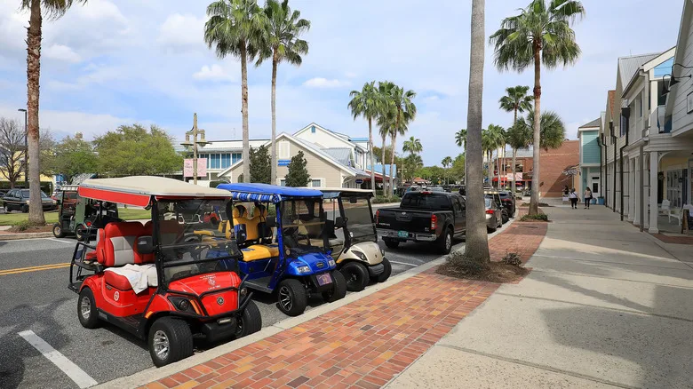 Golf carts parked in a parking lot