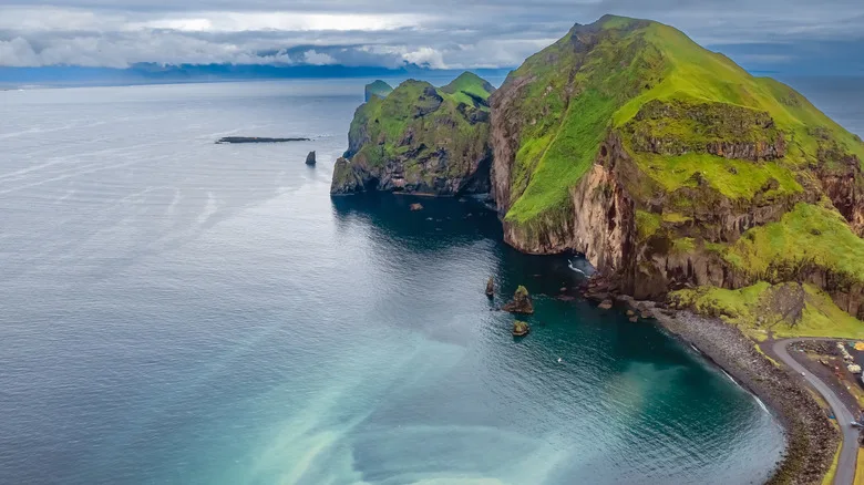 Aerial view of greenery-covered Westman Islands by the water in Iceland